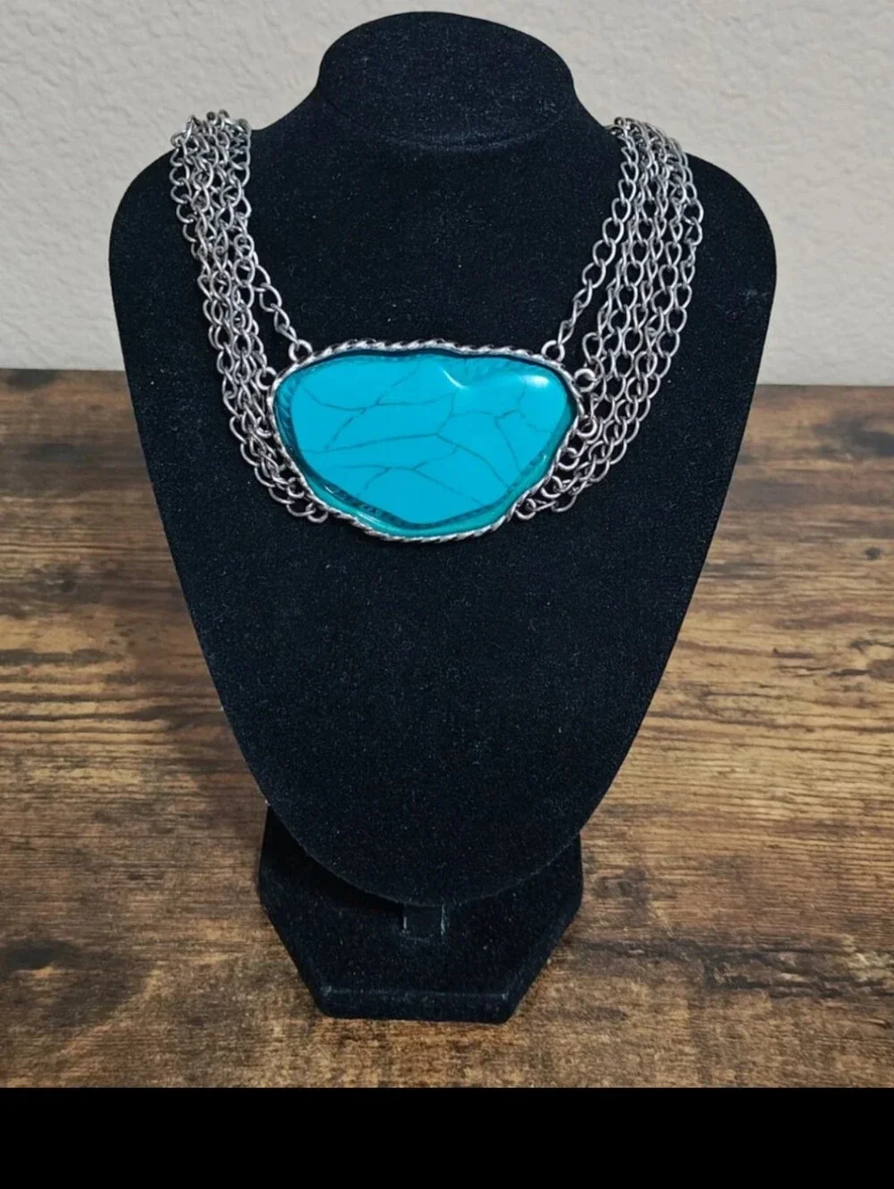 Silver Tone Multi Strand Chain Statement Necklace With a Faux Turquoise Stone
